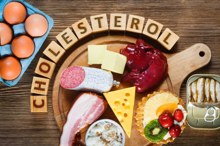 High cholesterol foods on wooden board