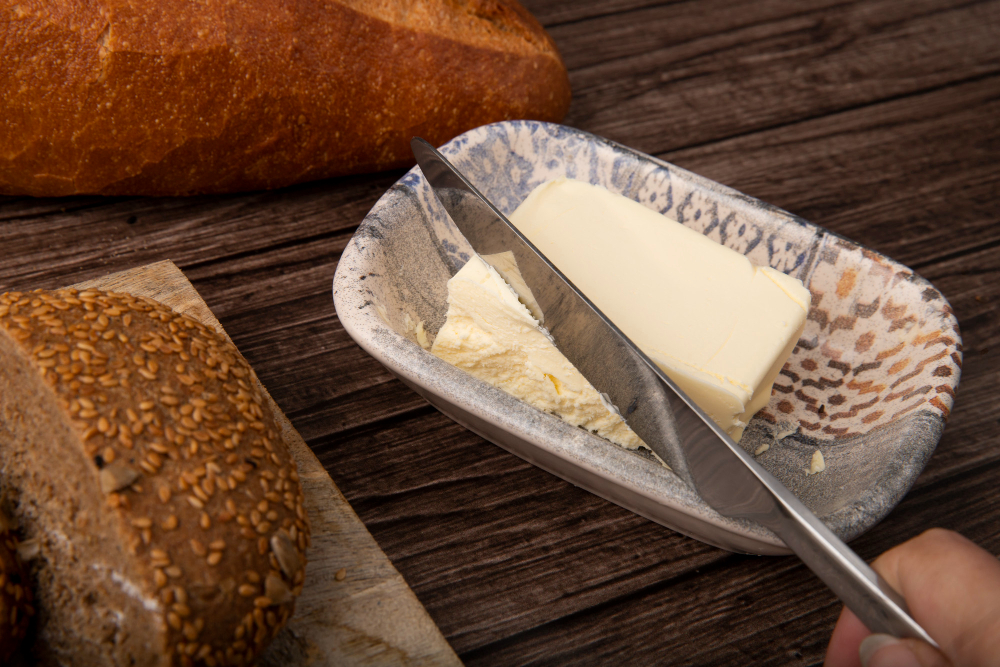 Spreading margarine on bread slic
