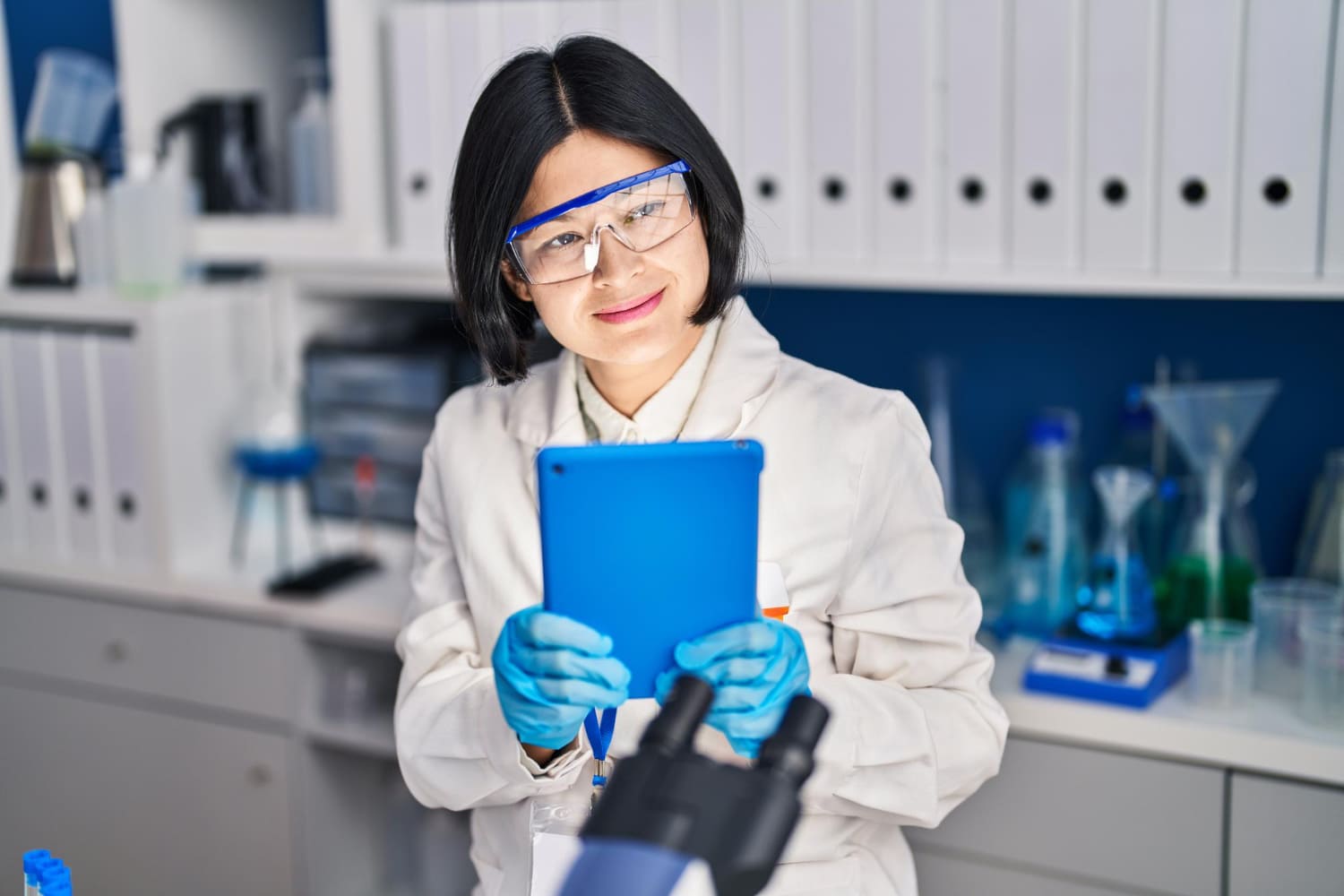 Young scientist using a touchpad working in a laboratory