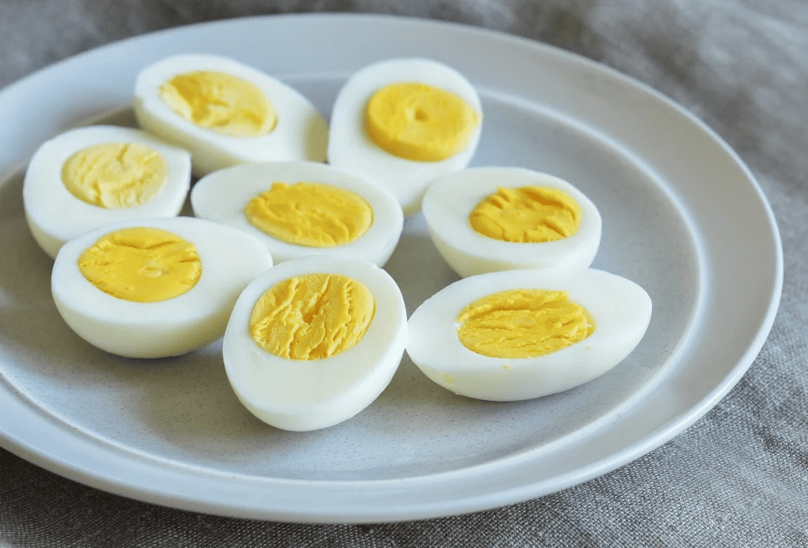 Boiled egg halves on a white plate