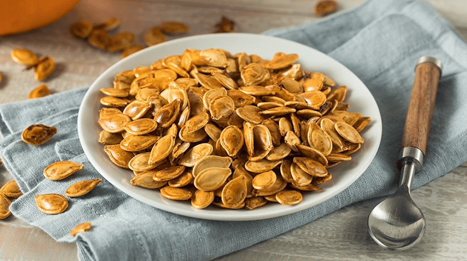 Roasted pumpkin seeds served on a plate