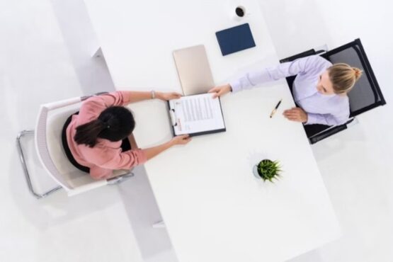 Two Women in an Office for Job Application and Hiring Agreement